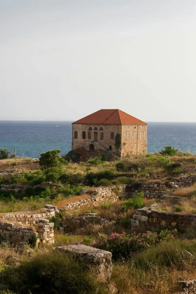 An old stone building sits on top of a hill overlooking the ocean in Lebanon Top 10 Fairytale Places